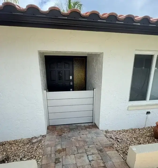 Custom aluminum flood barrier at a residential entrance